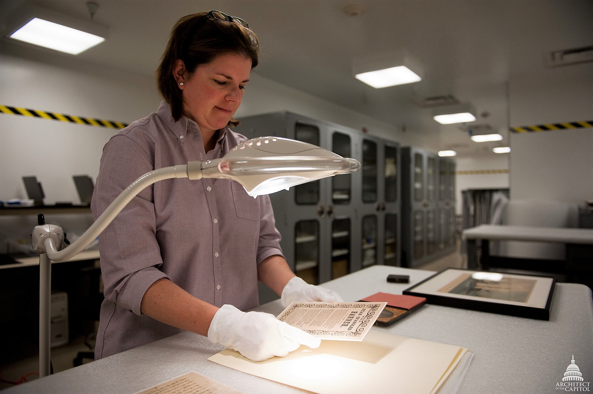 woman working on restoring documents